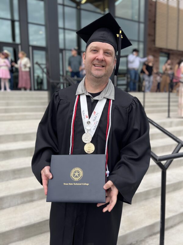 Sonny Bever in cap and gown at TSTC graduation for the Cybersecurity program